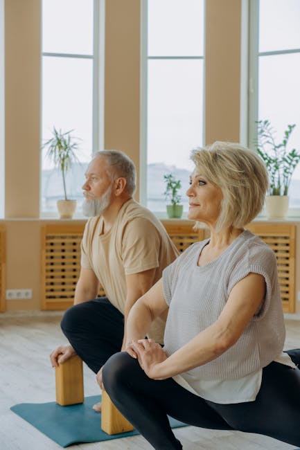 A group of people practicing yoga together in a spacious studio.